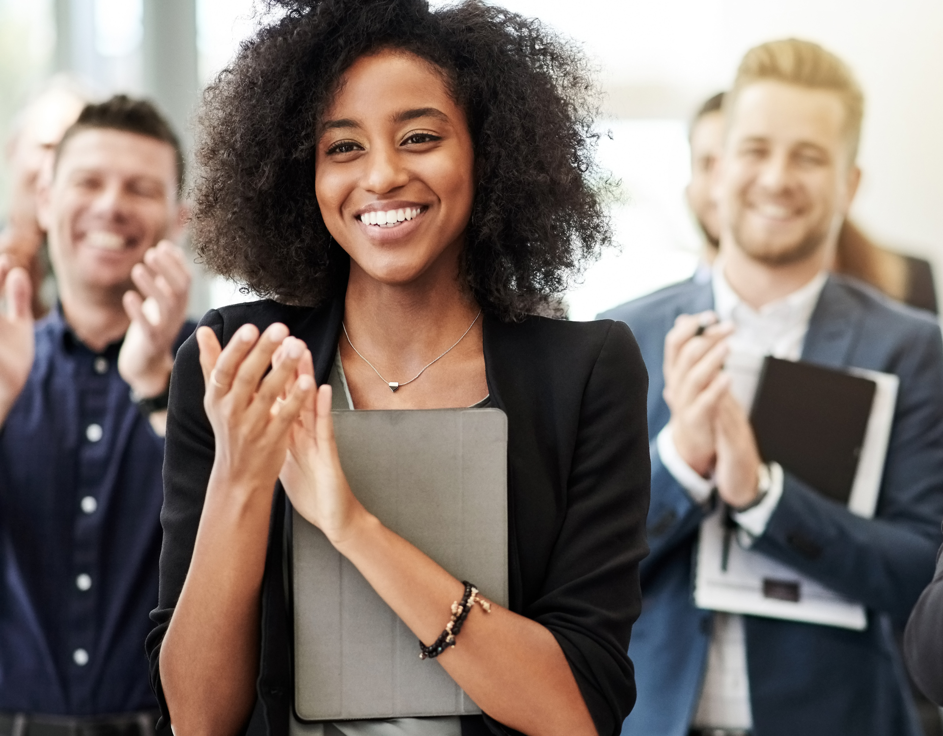 Professional applauding during a team event representing career growth and professional development.