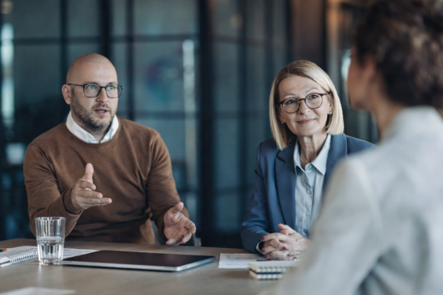 three middle aged professionals having a discussion