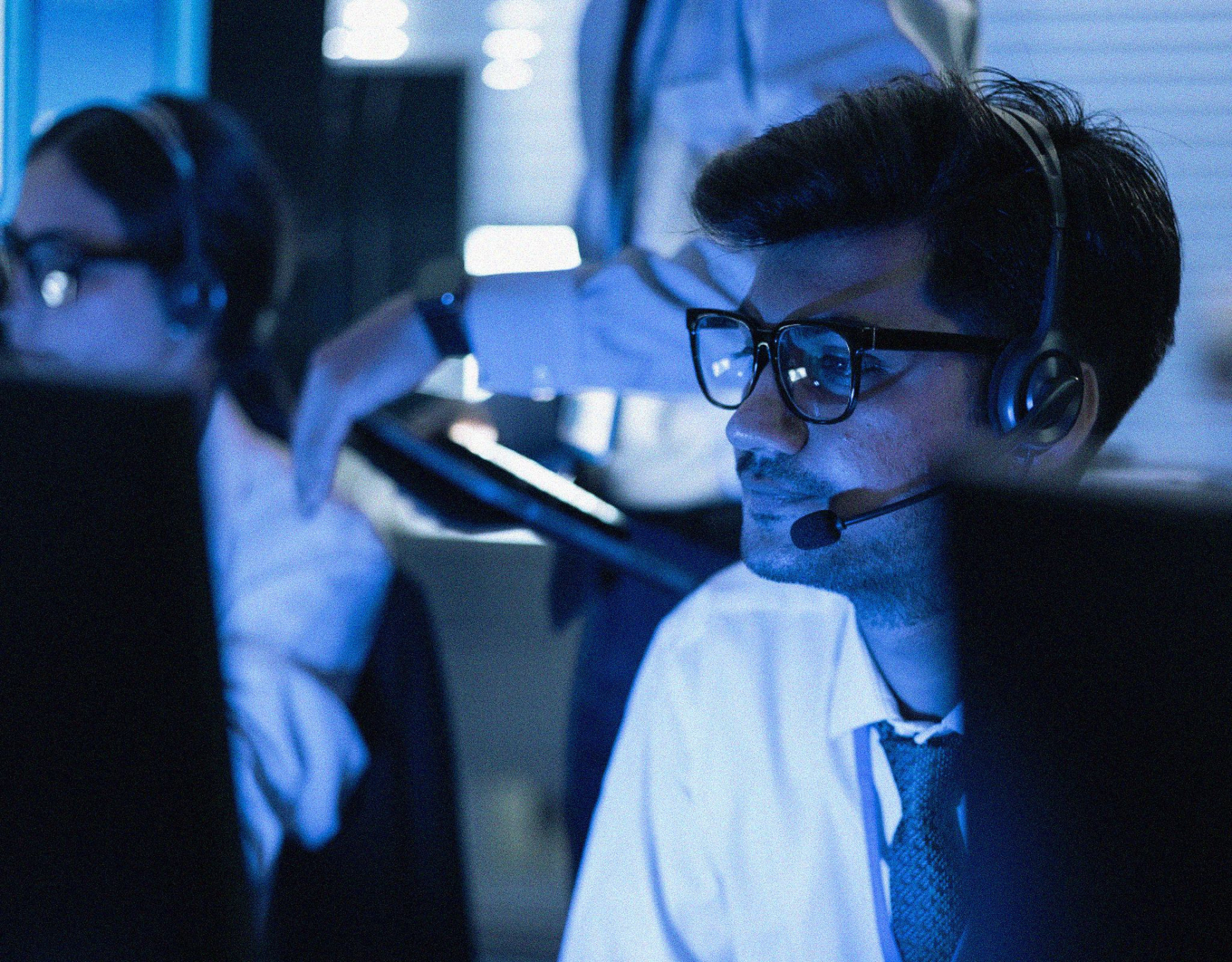 male with a headset working in a support center