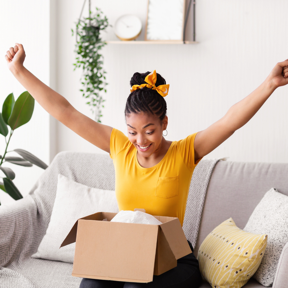 black young female celebrating receiving her order