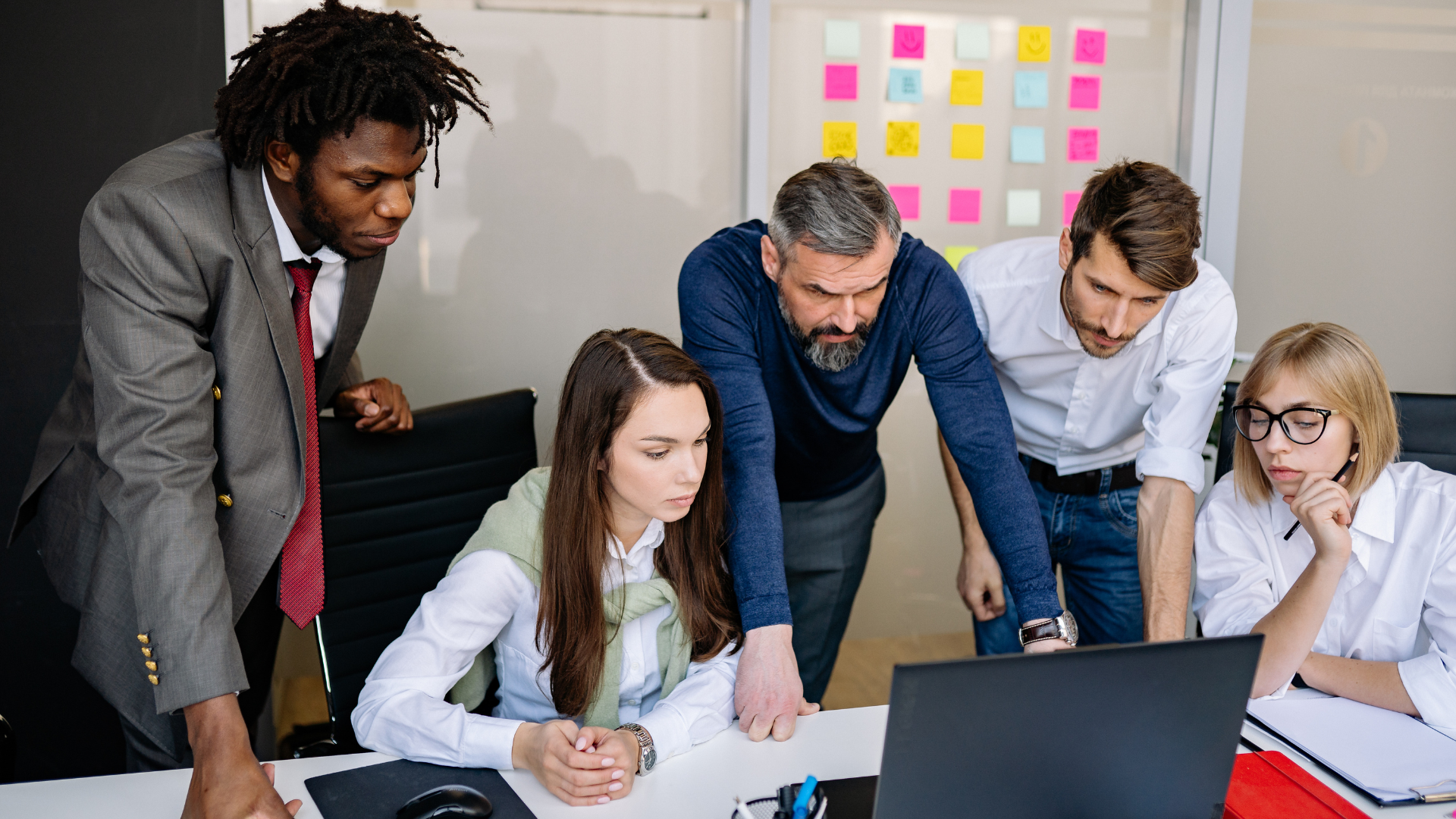 Team collaborating around a project board representing modern agile ways of working.
