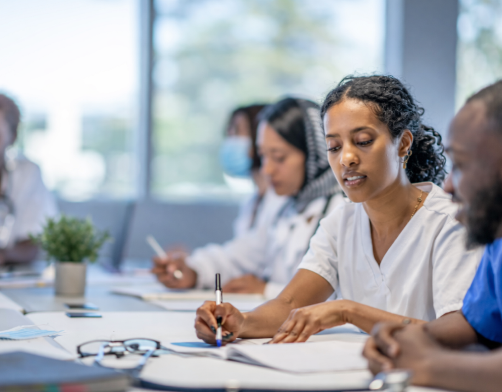 group of healthcare professionals examining paperwork