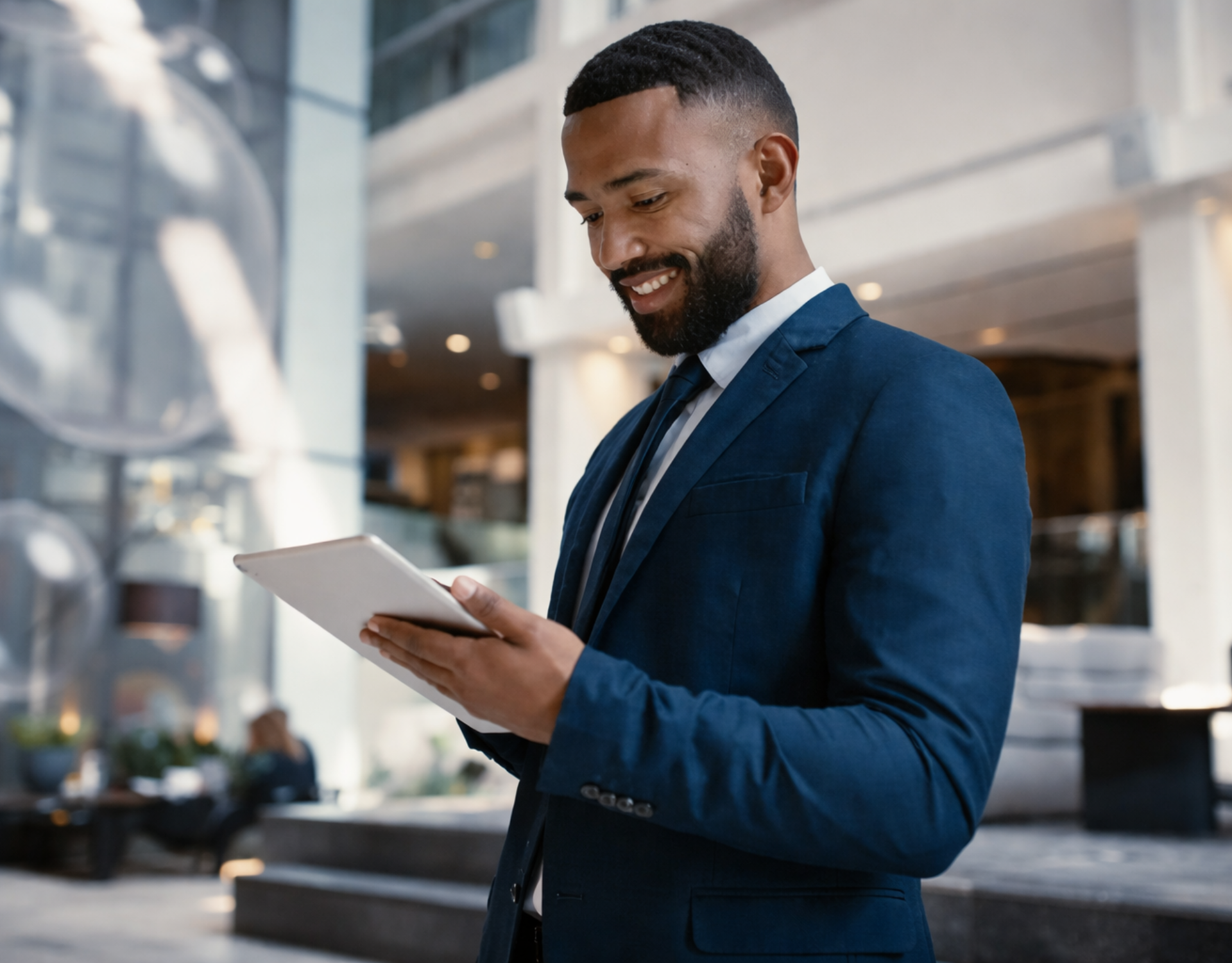 young male professional looking at his tablet screen