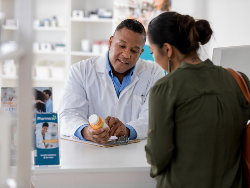 male pharmacist discussing medication to a patient