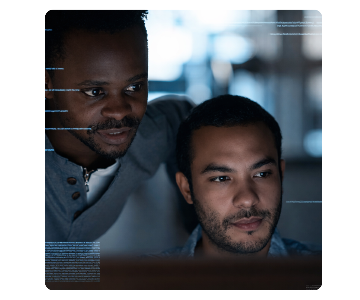 two men looking at a computer screen analyzing data