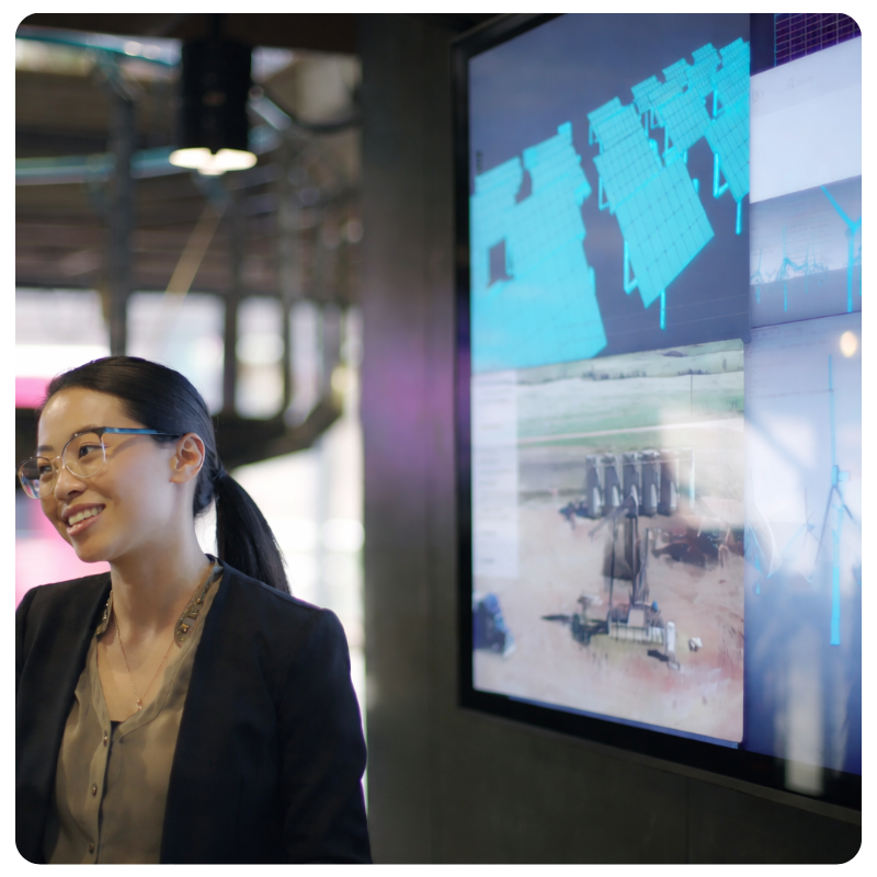 asian woman in glasses smiling giving a presentation
