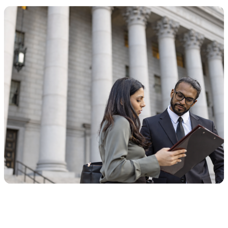 male and female professionals discussing business outside a government building