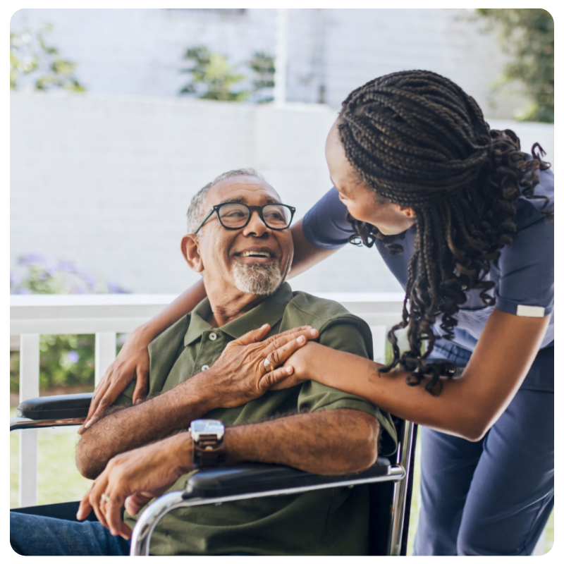 black female talking to a patient in a wheelchair