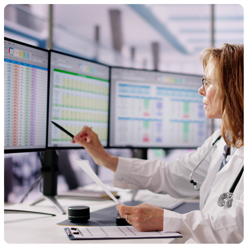white female doctor analyzing results on a computer monitor