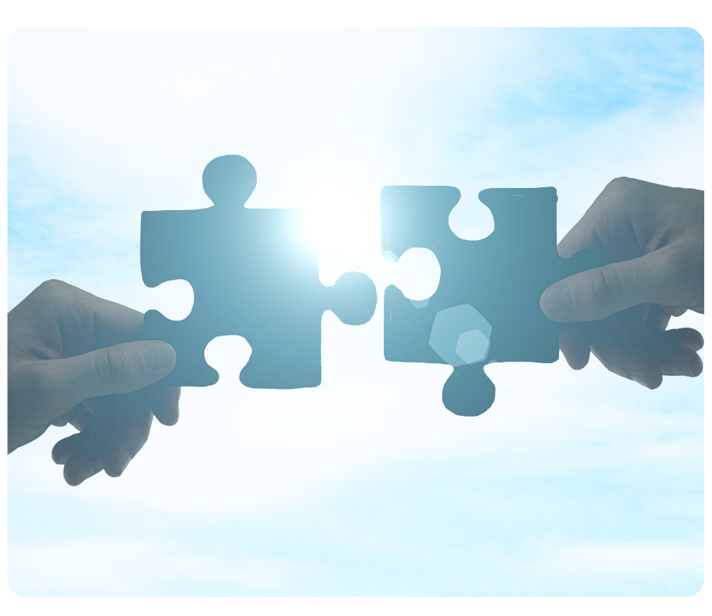 Two hands connecting puzzle pieces to represent collaboration and partnership