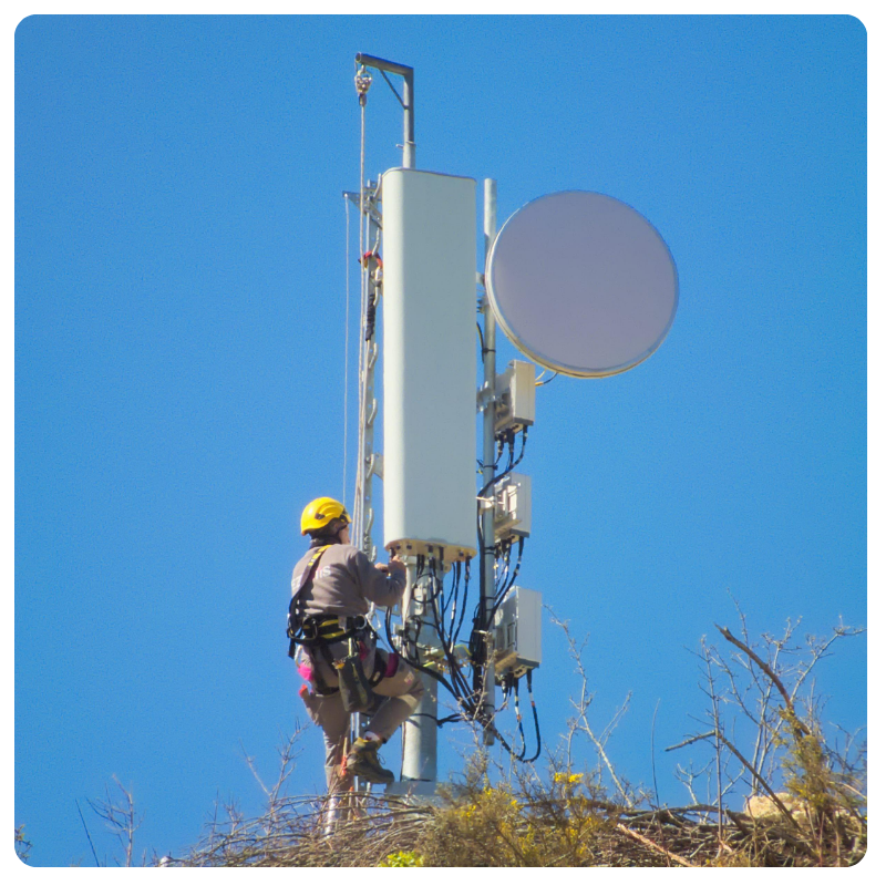 service technician climbing a cell tower