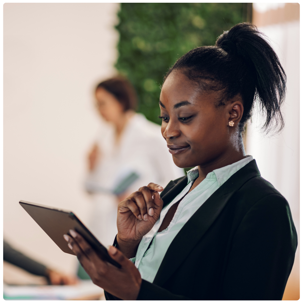 Technology professional reviewing operational data on a tablet. Technology professional reviewing operational data on a tablet.