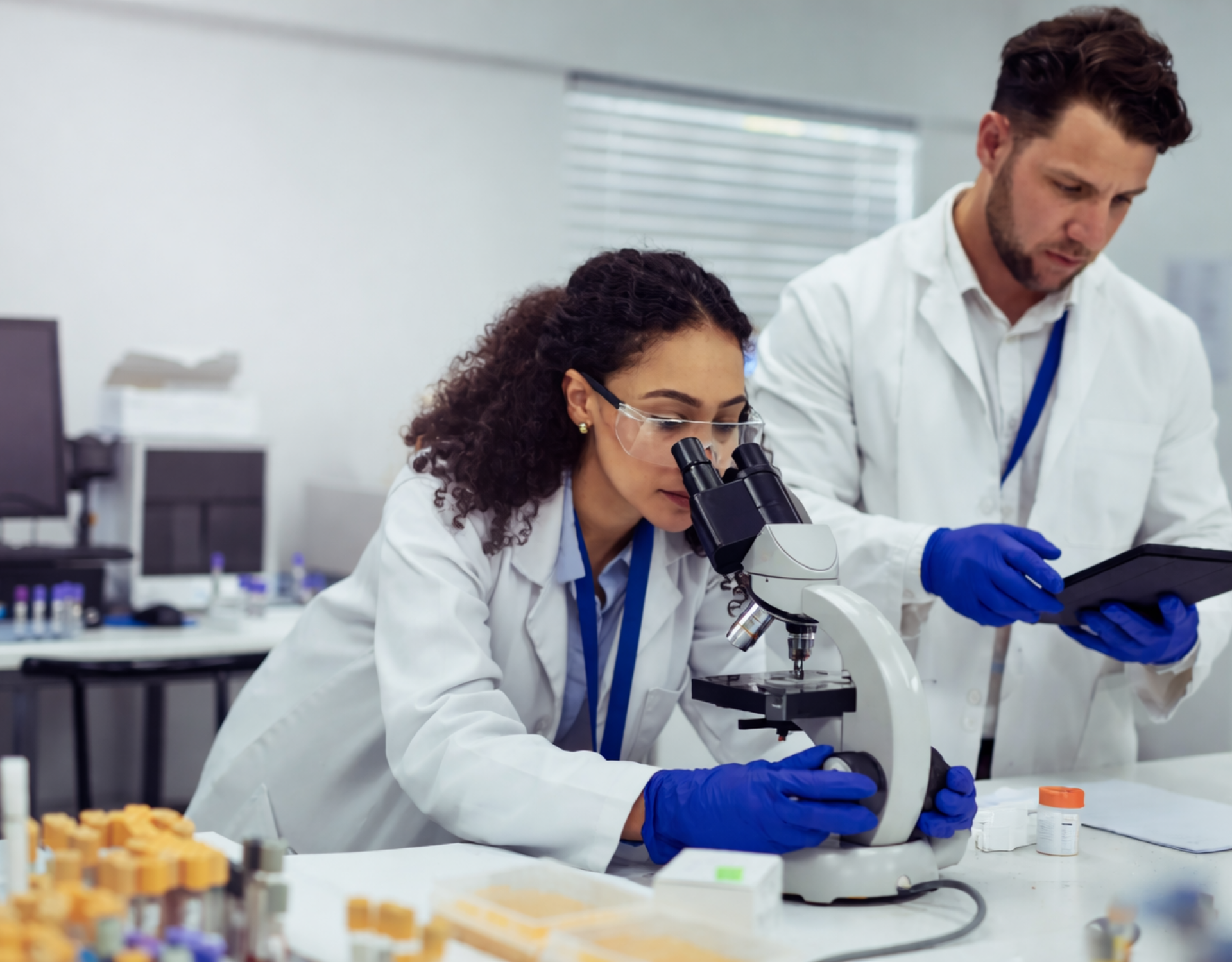 two scientists looking into a microscope (1)